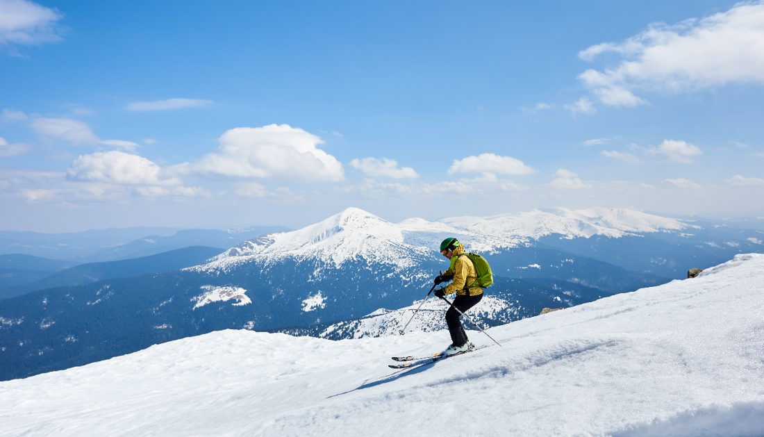 Skier carving down an alpine slope